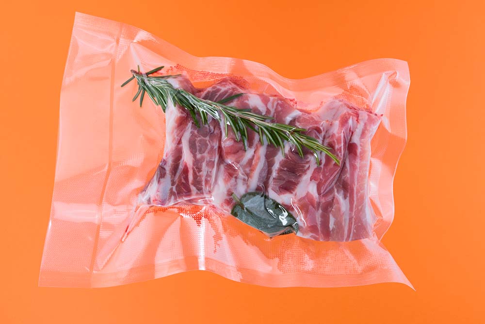 vacuum packaged spare ribs with rosemary in a sous vide bag