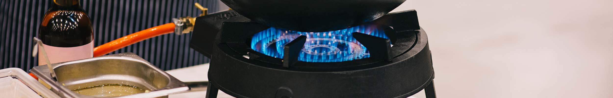 Durable outdoor wok burner on stand with blue flames