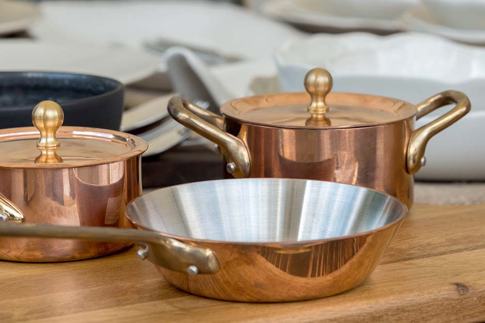 An array of copper pots and pans