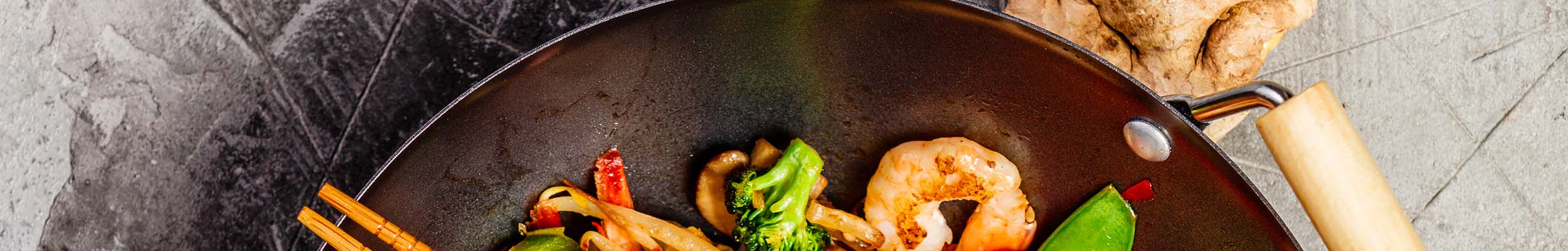 Double wood handle wok with stir fry shrimp with vegetables