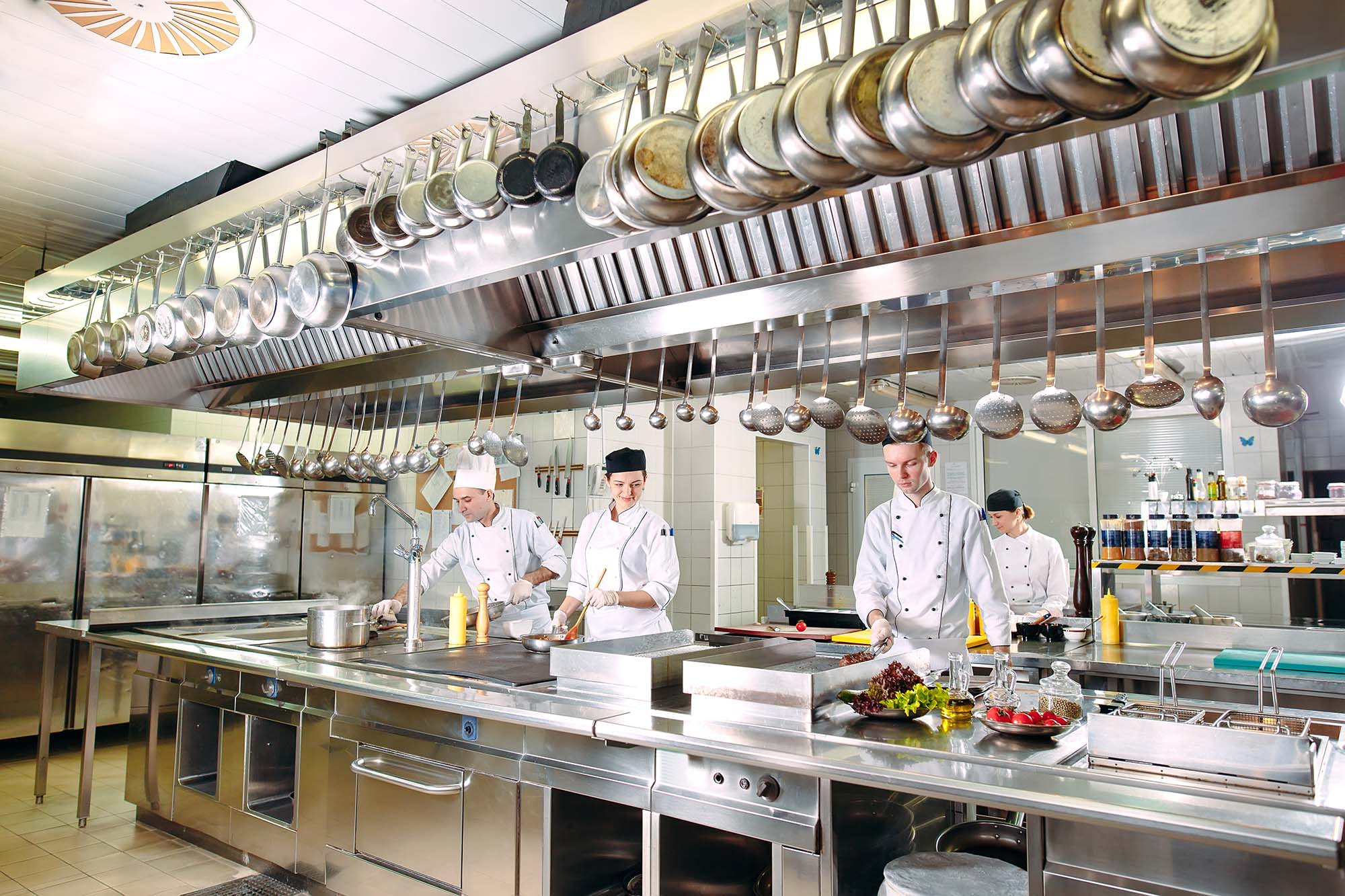 Commercial kitchen cookware chefs use hanging while they cook