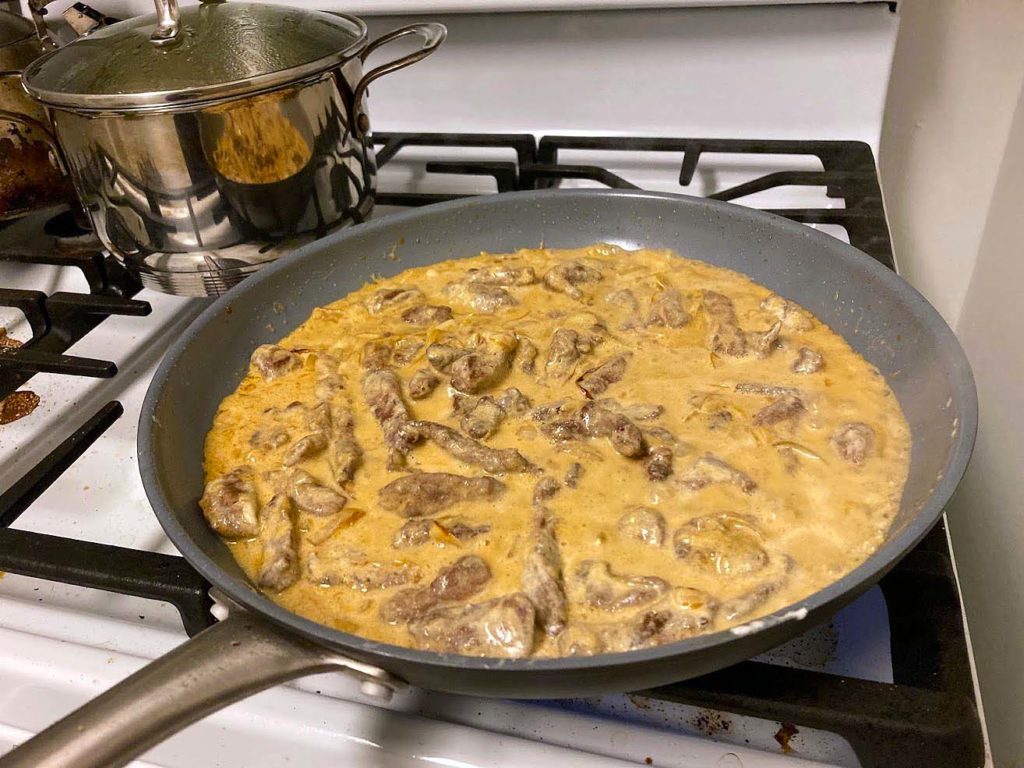 Beef stroganoff cooking on the stove. Looks a little like curry, but it's way better.