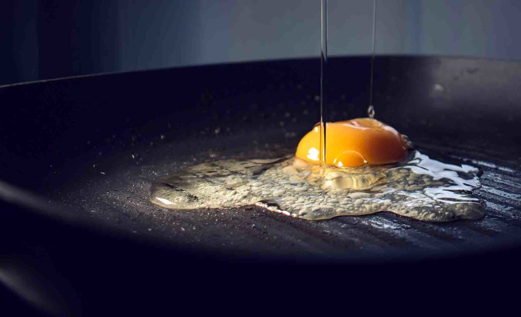 Egg frying on non-stick pan coated with PTFE